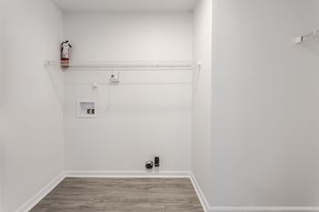 A white room with a fire extinguisher on the wall